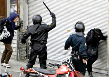 IRAN: Iranian security forces on motorcycles surround opposition protesters during clashes in Tehran on Dec. 27, 2009. Iran security forces killed several protesters including opposition leader Mir Hossein Mousavi's nephew in a fierce crackdown on mass anti-government demonstrations in Tehran. (Getty Images)
