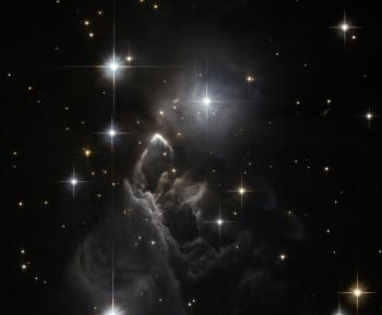 BOOMERANG - The luminescent boomerang-shaped halo shines distinctively at the upper edge of the 'Iras' ghost' nebula. (NASA)