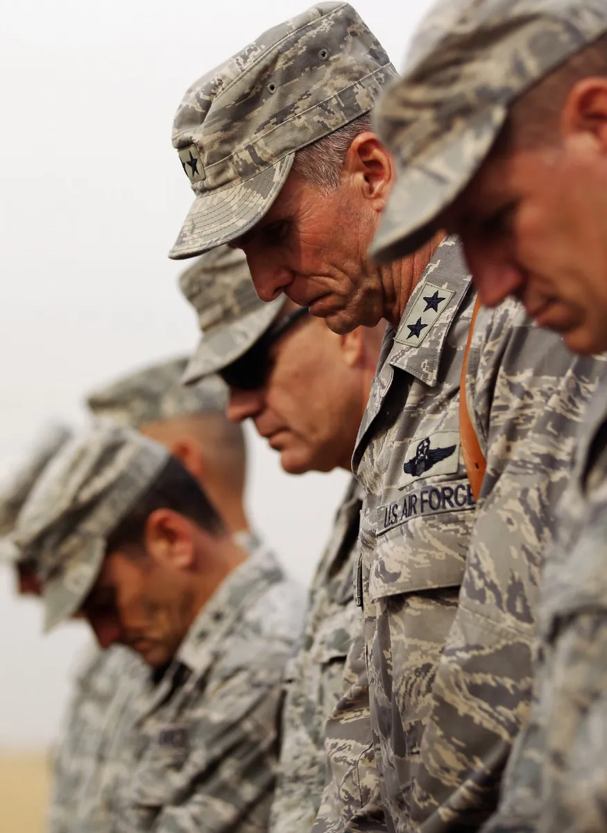 American soldiers bow their heads in prayer during a casing ceremony where the United States Forces- Iraq flag was retired, signifying the departure of United States troops from Iraq, at the former Sather Air Base on Dec. 15, 2011, in Baghdad, Iraq. (Mario Tama/Getty Images)