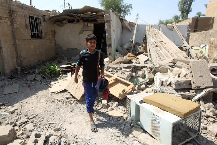 Elven-year-old Mohammad searches for salvageable items amid the rubble of his family's destroyed house following a series of bomb attacks in the town of Taji, north of Baghdad on July 23. (Ahmad Al-RubayeAFP/GettyImages)