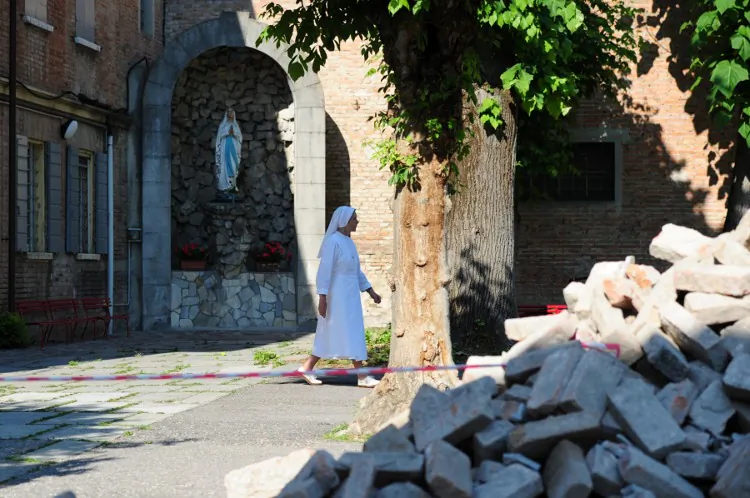 A nun walks past rubble in Mirandola after an earthquake on May 29. (OLIVIER MORIN/AFP/GettyImages)