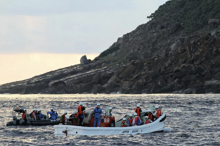 A team of Japanese surveyors conducts an offshore survey from boats near Uotsurijima island, part of the disputed island chain known in Japan as Senkaku and Diaoyu in China, on Sept. 2. (Jiji Press/AFP/GettyImages)