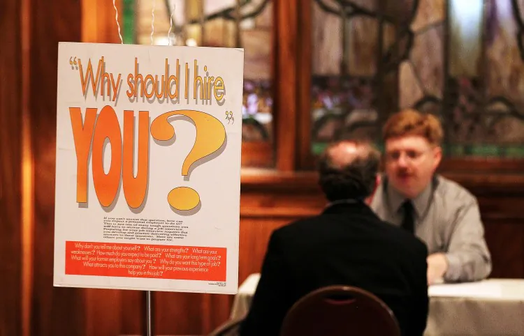A Job seeker has his resume reviewed during a job fair in San Francisco, July 12, 2011. (Justin Sullivan/Getty Images)