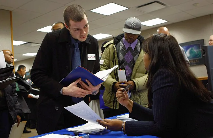 Former U.S. Marine Sean Ghigliotty, unemployed for nine months, meets a potential employer during a veterans job fair Feb. 1 in New York City. According to a report released Feb. 3 by the Bureau of Labor Statistics, 257,000 jobs were added to the private sector in January. (John Moore/Getty Images)
