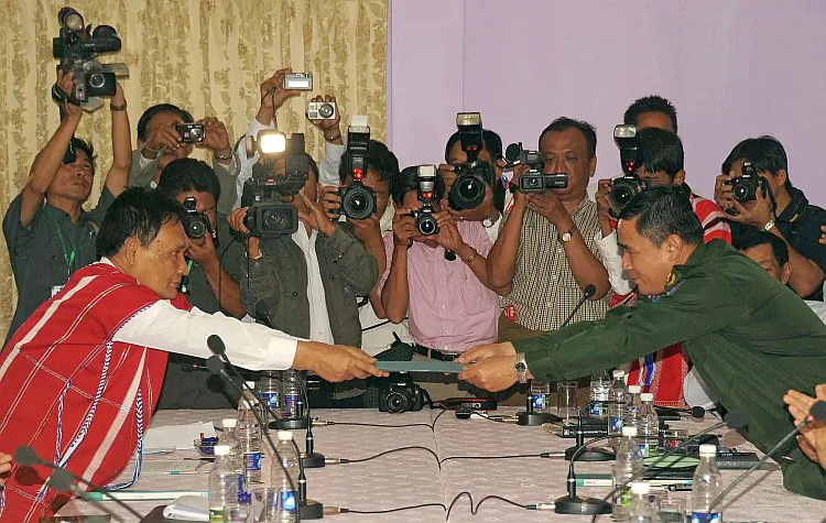 A Burmese official (R) exchanges documents with a representative of the Karen National Union after signing a ceasefire agreement in the city of Hpa-an, Burma, on Jan. 12. (Soe Than Win/AFP/Getty Images)