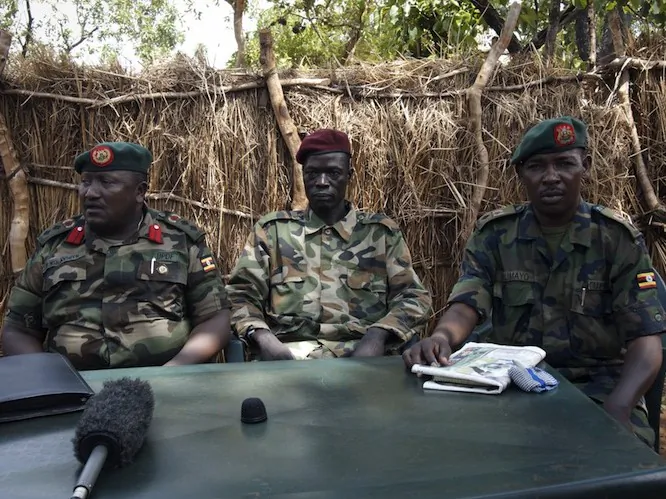 Ceasar Acellam, a senior member of the Lord's Resistance Army, (C), Ugandan army spokesman Felix Kulayigye (L) and a Uganda People's Defence Force commander speak to the press at the Ugandan army base in Djema on May 13, 2012. (Michele Sibiloni/AFP/GettyImages)