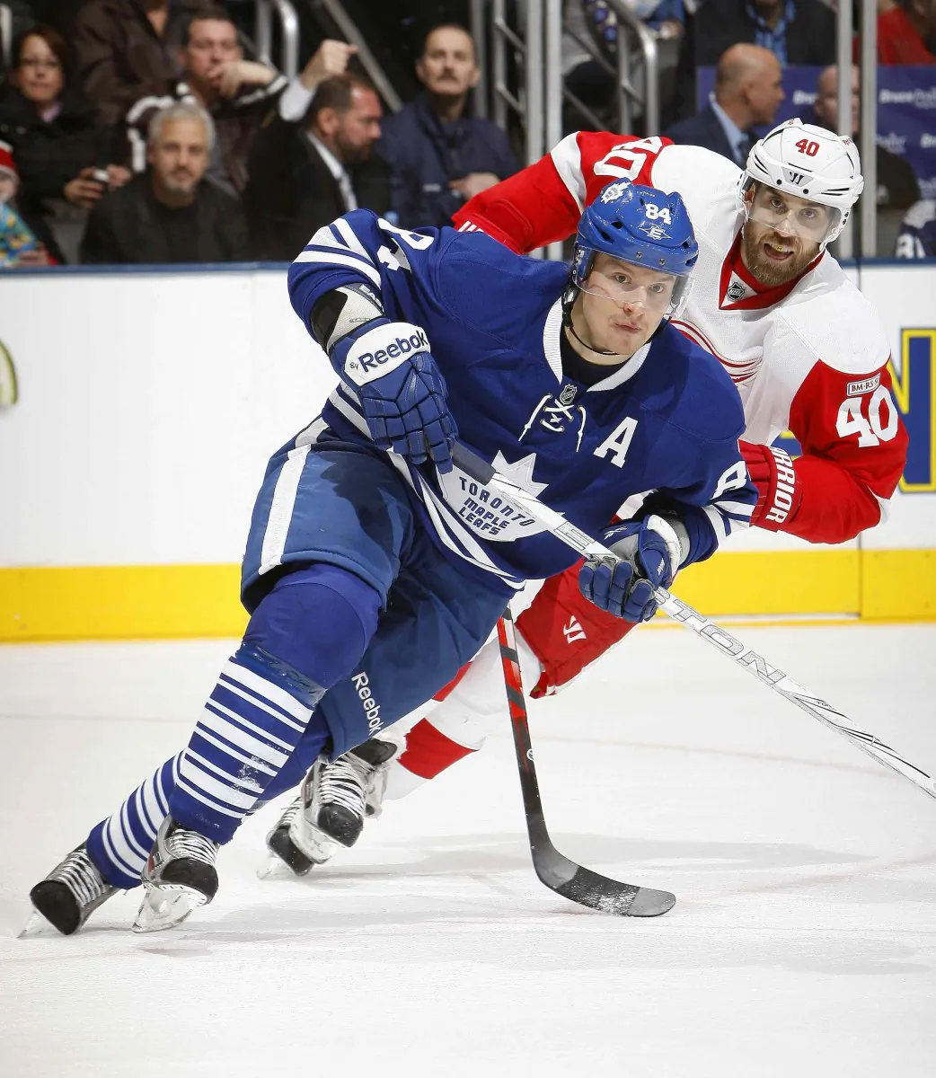 Mikhail Grabovski of the Toronto Maple Leafs is pursued by Henrik Zetterberg of the Detroit Red Wings in a game at the Air Canada Centre on Jan. 7, 2012. The new NHL realignment has Detroit and Toronto in the same division once again. (Abelimages/Getty Images)