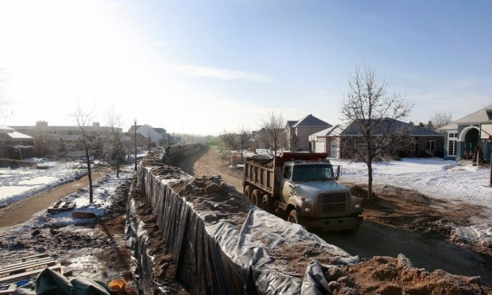 A levee holds back flood water from the Red River, N.D. U.S. Levees and waterways form a "hidden backbone" of the U.S. freight network and yet age and deterioration are causing significant delays and affecting commerce according to a new report on U.S. infrastructure. (Scott Olson/Getty Images)
