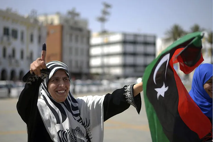 A Libyan woman celebrates in Martyrs' Square in Tripoli after voting for the Libyan General National Assembly on July 7. Eager voters cast ballots in Libya's first free national elections for decades after the ouster of dictator Moammar Gadhafi, but protesters disrupted some polling in the troubled east. (Gianluigi Guercia/AFP/GettyImages)
