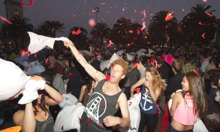 People participate in a massive pillow fight at Justin Herman Plaza in San Francisco, Calif., on Feb. 14, 2013. (Alex Ma/The Epoch Times)