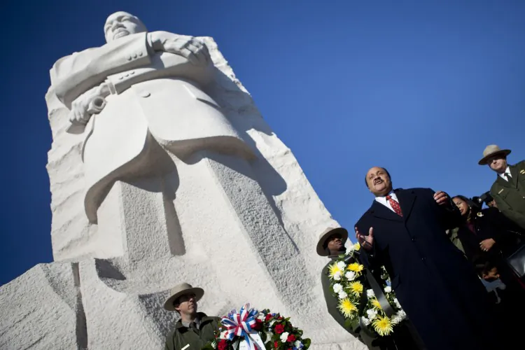 Martin Luther King III speaks at the base of a statue to his father after a wreath-laying ceremony at the Martin Luther King Jr. Memorial on the National Mall Jan.15, in Washington. (Brendan Smialowski/Getty Images)