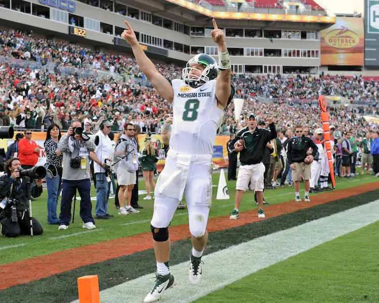 Michigan State quarterback Kirk Cousins celebrates a touchdown in the Spartans 33-30 3-OT victory on Monday in the Outback Bowl. (Al Messerschmidt/Getty Images)