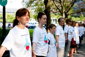 At an event called 'Hand-in-Hand, Remembering 9/11,' people stand in Battery Park at the beginning of a human chain that stretches to Chambers Street on Saturday. (Tara MacIsaac/The Epoch Times)