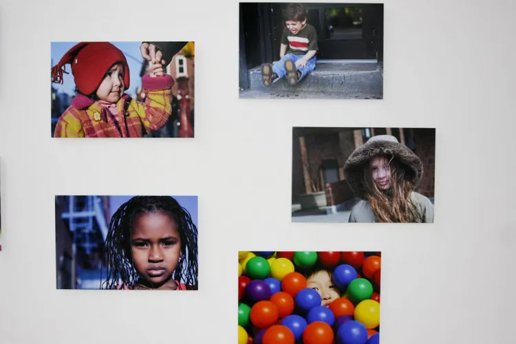 Some of Danny Goldfield’s photos of New York City children from around the world on display at Park51. Top right, Lola from Czech Republic; bottom right, Jennifer, Daniel, and Caesar from Honduras; center, Rhianna and Celeste from the United Kingdom; bottom left, Keinaan from Somalia; center left, Calvin and Samira from Indonesia; top left, Nathaniel from Canada. (Tara MacIsaac/The Epoch Times)