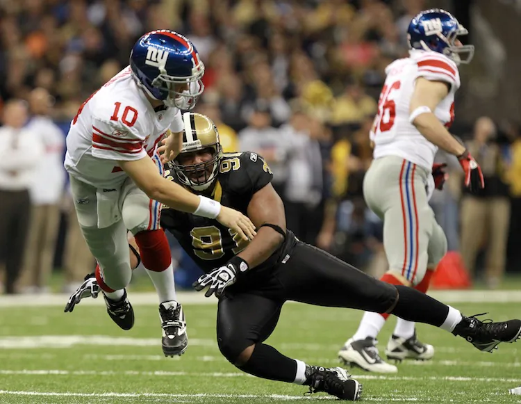 Eli Manning (10, falling) and his Giants will have to regroup to take down the undefeated Packers. (Ronald Martinez/Getty Images)