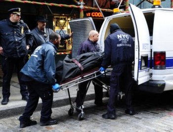 The body of Mark Madoff, the son of disgraced financier Bernard Madoff, is removed by medical examiners after he apparently hanged himself in his New York apartment on Dec. 11, 2010, the second anniversary of his father's arrest for perpetrating Wall Street's biggest ever fraud. (Emmanuel Dunand/AFP/Getty Images)
