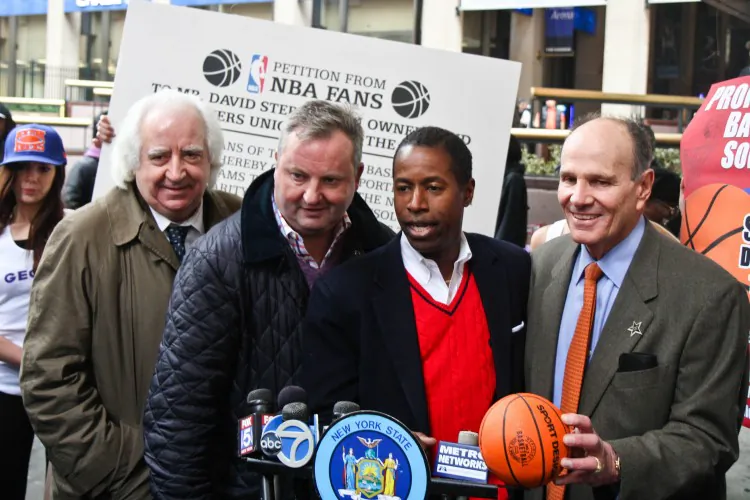 Ian Titus shows 10-year-old Antonio where to sign an NBA petition in front of Madison Square Garden on Wednesday. The petition urges NBA players to get back to work. (Kristen Meriwether/Epoch Times)
