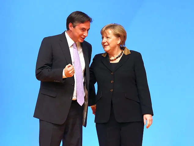 German Chancellor Angela Merkel, who is also chairwoman of the German Christian Democratic Union (CDU), greets delegates with Gov. of Lower Saxony David McAllister at the CDU federal party convention in Hanover, Germany, on Dec. 4, 2012. Lower Saxony is holding state election on Jan. 20, 2013, and some analysts see the election as a bellwether for general election scheduled to take place in September. (Sean Gallup/Getty Images)