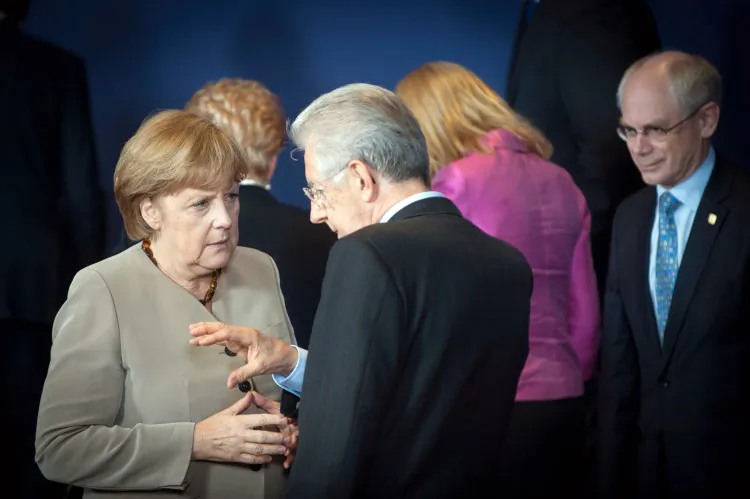 Germany Chancellor Angela Merkel (L) speaks with Italian counterpart Mario Monti (C), as European Council President Herman Van Rompuy (far R) looks on, during the opening session of the Meeting of the European Council on June 28, in Brussels, Belgium. (Guido Bergmann/Bundesregierung - Pool/Getty Images)