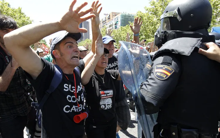 Demonstrators shout in front of riot policemen during a coal miners' demonstration in Madrid July 11. Miners are protesting industry subsidy cuts they say threaten their communities. (Cesar Manso/AFP/GettyImages)