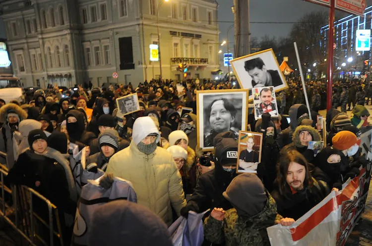 People hold portraits of a killed journalist and a lawyer during a rally at the Pushkinskaya Square in central Moscow, on Jan. 19, 2012. A journalist who worked for a state-run broadcaster was shot and killed in the North Caucasus on Dec. 5. (Andrey Smirnov/AFP/Getty Images)