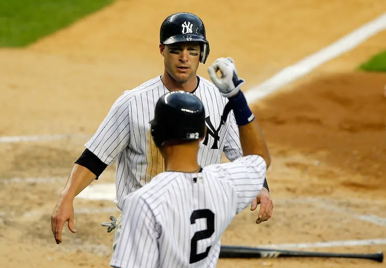 Derek Jeter (2) congratulates Jayson Nix as the Yankees completed their eight series sweep of the season. (Jim McIsaac/Getty Images)