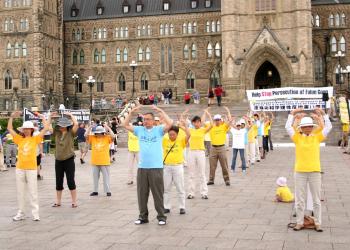 Falun Gong practitioners perform the Falun Standing Stance on Parliament Hill in Ottawa on July 18, 2010. It is the second of five meditative exercises of the Falun Gong cultivation system, and consists of four wheel-holding positions. (The Epoch Times) Falun Gong practitioners perform the Falun Standing Stance on Parliament Hill in Ottawa on July 18, 2010. It is the second of five meditative exercises of the Falun Gong cultivation system, and consists of four wheel-holding positions. (The Epoch Times)