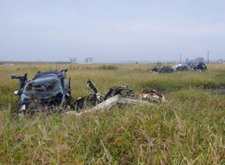 Mangled cars in the Arahama District of Sendai City still lie where they were deposited by the Japan tsunami on March 11. The now overgrown fields were thriving farms before the disaster. (Cindy Drukier/The Epoch Times)