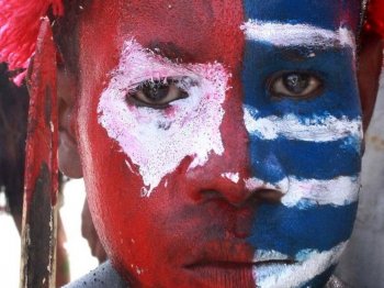 A Papuan tribesman's face is painted with the color of the banned separatist flag during a rally in Jayapura on July 8, urging the provincial Parliament to demand a referendum on self-determination.