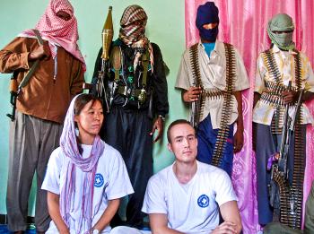 ABDUCTED: A Japanese doctor (bottom-L) and a Dutch nurse (bottom-R) are shown to journalists by their Somali kidnappers at an undisclosed location in Mogadishu on October 10, 2008. Relief work has become increasingly risky over the last decade with with kidnappings and killings increasing in frequency. (AFP/Getty Images) ABDUCTED: A Japanese doctor (bottom-L) and a Dutch nurse (bottom-R) are shown to journalists by their Somali kidnappers at an undisclosed location in Mogadishu on October 10, 2008. Relief work has become increasingly risky over the last decade with with kidnappings and killings increasing in frequency. (AFP/Getty Images)