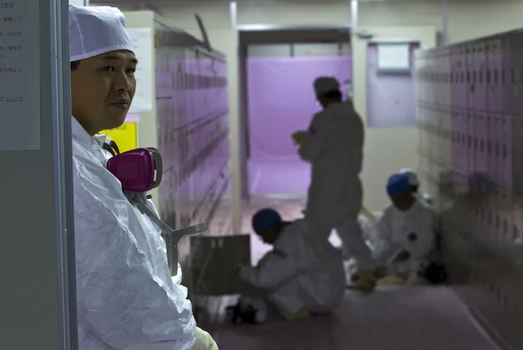 Japanese workers wearing protective suits gather near their lockers inside the emergency operation center at the Fukushima Daiichi nuclear power station in Okuma on Nov. 12, 2011. (David Guttenfelder/AFP/Getty Images)