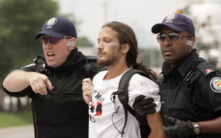 Police arrest a protester outside the temporary G-20 police detention center, where over hundreds of people were detained on June 27, 2010 in Toronto, Canada. (Simon Hayter/Getty Images)