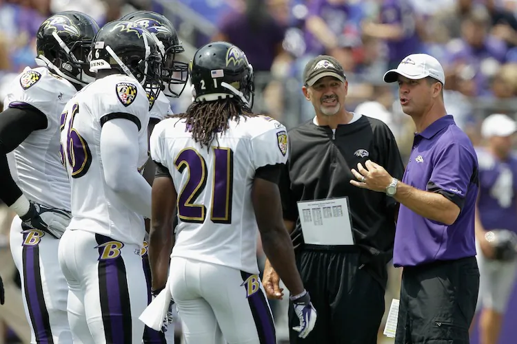 Chuck Pagano (center, in black) led a Ravens' defense that finished third in points and yards allowed. (Rob Carr/Getty Images)