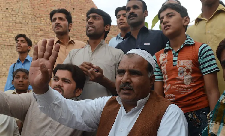 Pakistani villagers talk to media representatives following the execution of Mohammed Ajmal Kasab, who was the sole surviving gunman of the 2008 Mumbai attacks, at Kasab's village in Farid kot, on Nov. 21, 2012. (Arif Ali/AFP/Getty Images)