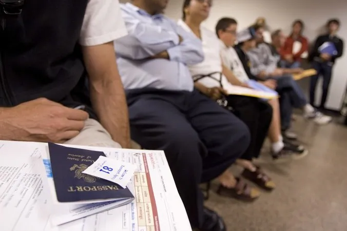 People wait to get their passport applications submitted at the United States passport agency office in San Francisco in this file photo. Two U.S. senators have sponsored a bill to allow foreigners who purchase real estate in the United States to extend their visa stay. (David Paul Morris/Getty Images)