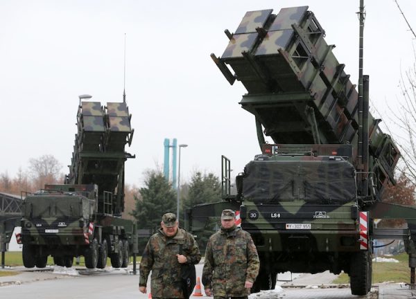Soldiers of the Air Defense Missile Squadron 2 walk past Patriot missile launchers in the background in Bad Suelze, Germany, on Dec. 4, 2012. Germany's cabinet authorized on Dec. 6 the sending of Patriot missiles to Turkey for defense against violence along the Syrian border. (Gernd Wustneck/AFP/Getty Images)