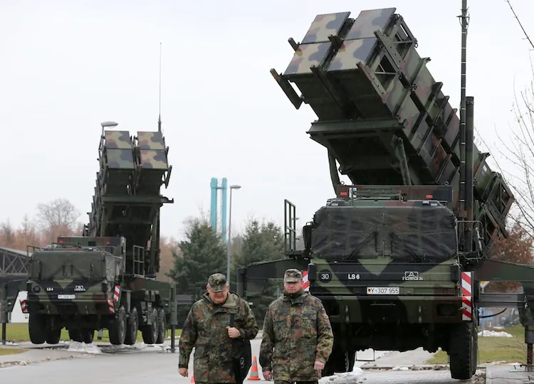 Soldiers of the Air Defense Missile Squadron 2 walk past Patriot missile launchers in Bad Sülze, Germany, on Dec. 4, 2012. Germany's cabinet authorized on Dec. 6 the sending of Patriot missiles to Turkey for defense against violence along the Syrian border. (Gernd Wustneck/AFP/Getty Images)