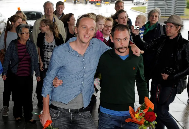Swedish reporters Martin Schibbye (L) and Johan Persson pose on arrival at Arlanda Airport in Stockholm on Sept. 14. Ethiopia pardoned and freed the reporters after they were jailed for "supporting terrorism" and for illegally crossing into Ethiopia from Somalia with rebels. (Anders Wiklund/AFP/GettyImages)
