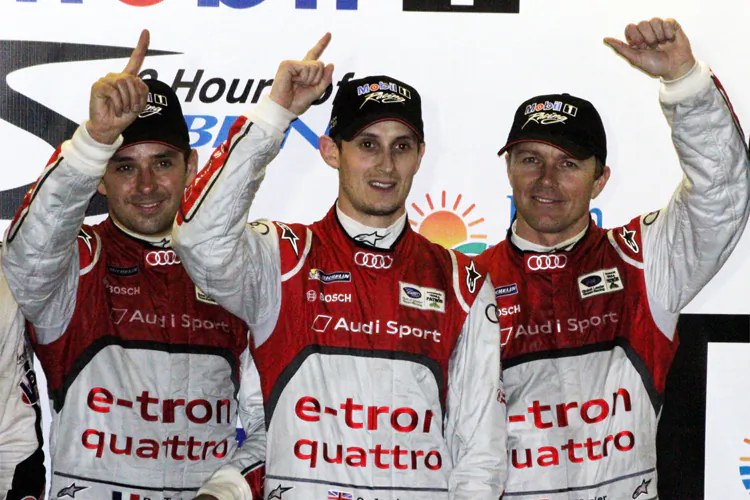 Benôit Tréluyer, Oliver Jarvis, and Marcel Fässler celebrate on the podium after winning the 61st Mobil 1 Twelve Hours of Sebring. (James Fish/The Epoch Times)