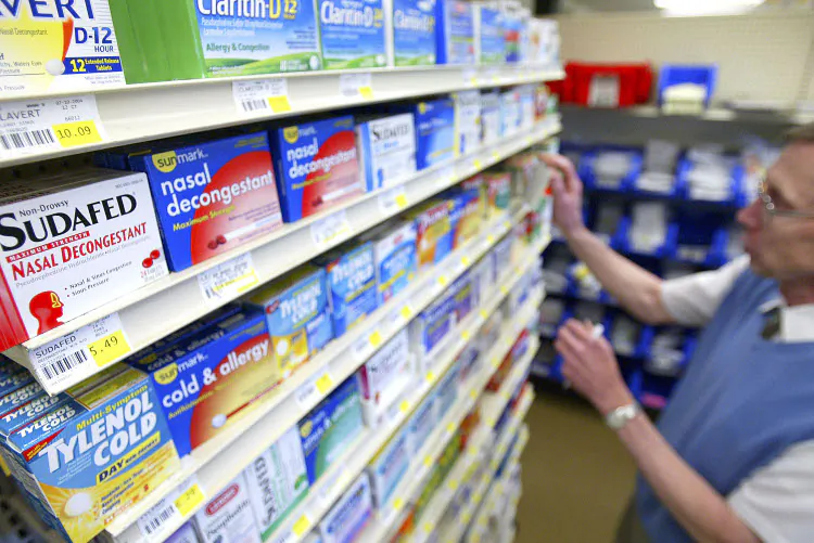 A pharmacist stocks cold medicines at a pharmacy in Milwaukie, Oreg., in this file photo. (Craig Mitchelldyer/Getty Images)