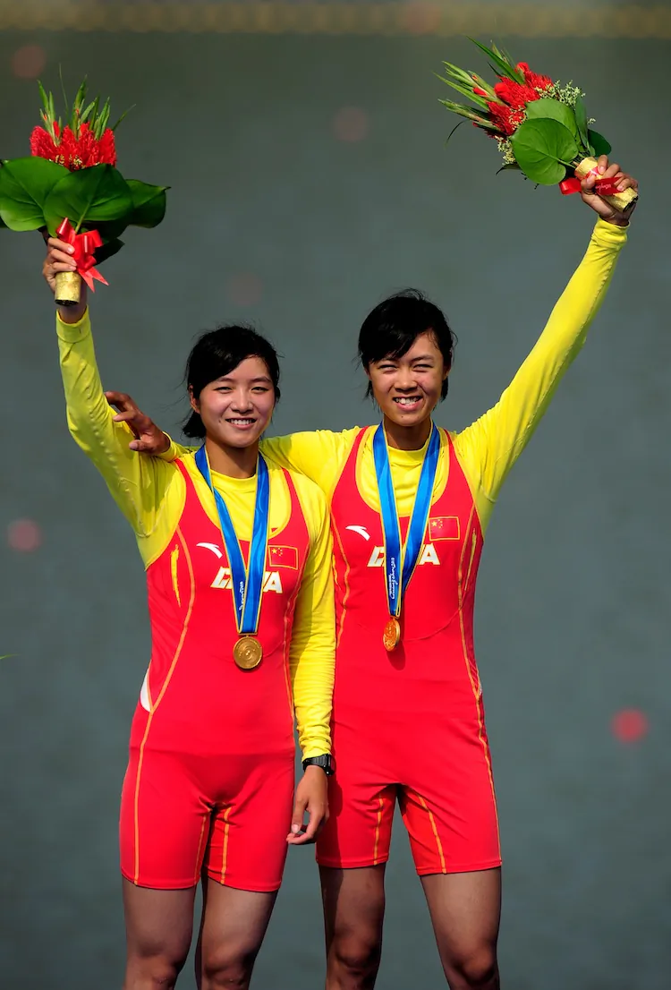 Rowers Wenyi Huang and Feihong Pan of China win gold during the 16th Asian Games in Guangzhou, Nov. 18, 2010. Chinese athletes have their own food supply chain—but even then, keep away from pork because of drugs that are fed to the pigs. (Jamie McDonald/Getty Images)