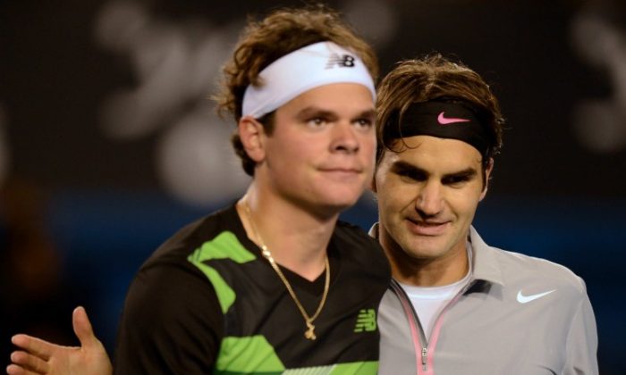 Milos Raonic (L) and Roger Federer meet at the end of the fourth round match at the Australian Open on Monday. Federer advanced to the quarterfinals. (Greg Wood/AFP/Getty Images)