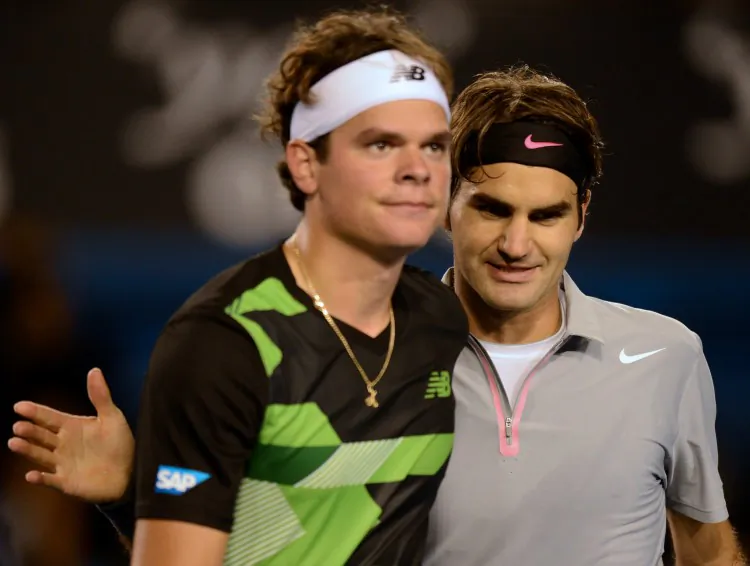Milos Raonic (L) and Roger Federer meet at the end of the fourth round match at the Australian Open on Monday. Federer advanced to the quarterfinals. (Greg Wood/AFP/Getty Images)