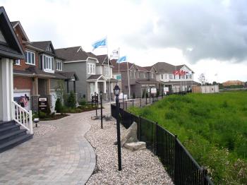 WIRED AND CONNECTED: Models of the connected singles, executive townhomes, and semi-detached homes being built by Monarch, Tartan, and Valecraft in the Kanata Smart Community neighbourhood of Sohowest in the west end of Ottawa. (Cindy Chan/The Epoch Times)