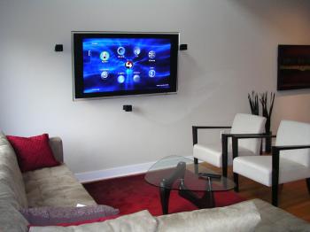 WIRED TO ENTERTAIN: A clean and wire-free home theatre in the Sohowest living room with a wall-mounted LCD TV. All the components are out of sight in the basement and connected to the TV through in-wall wiring. (Cindy Chan/The Epoch Times)