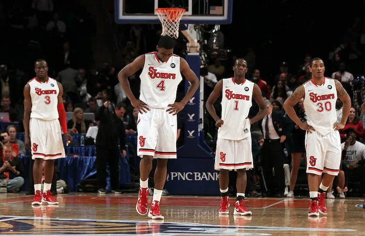 Red Storm players (L-R) God'sgift Achiuwa, Moe Harkless, Phil Greene, and Jamal White appear tired late in the game Tuesday. (Jim McIsaac/Getty Images)