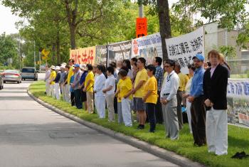 Falun Gong practitioners display banners in front of the Chinese embassy to raise awareness about the persecution of their practice by the Chinese regime that has persisted July 20, 1999. (Johansson Ren/The Epoch Times)