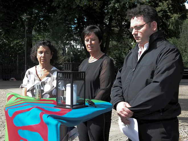 Lena Posner-Korosi (L), president of the Official Council of Jewish Swedish Communities, former Social Democrat leader Mona Sahlin (C) and Domino Kai from the Equality Ombudsman's office, observe a minute of silence at a memorial event for "Gypsy night" in Stockholm, Aug. 2. (Mikael Iso-Oja/ The Epoch Times)