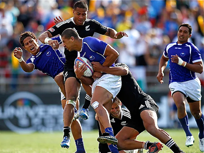 Samoa’s Uale Mai (with ball) fights through three New Zealand defenders during the USA Sevens Rugby tournament in Las Vegas, Nev. (Jonathan Ferrey/Getty Images)