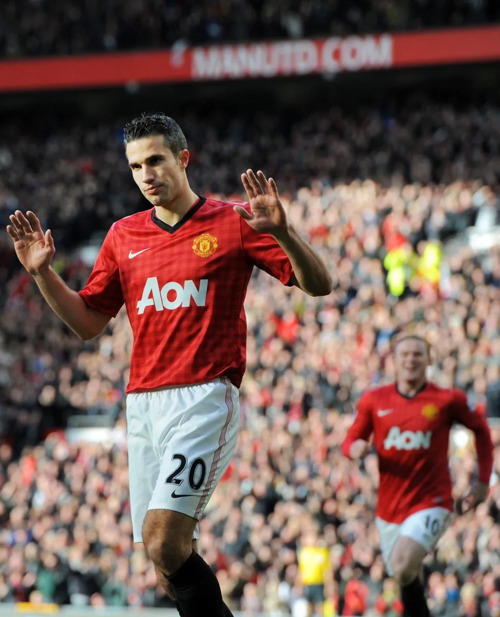 Robin van Persie didn’t show much emotion after scoring in the third minute against his former club Arsenal on Saturday at Old Trafford. (Andrew Yates, Paul Ellis/AFP/Getty Images)